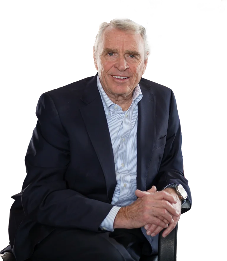 Phil Geldart founder and CEO of Eagle's Flight sitting on a chair and posing for a photo